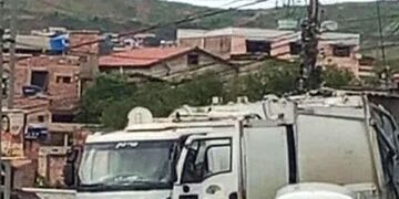 Caminhão de lixo enfrenta dificuldade para passar em rua estreita de Itabira durante coleta